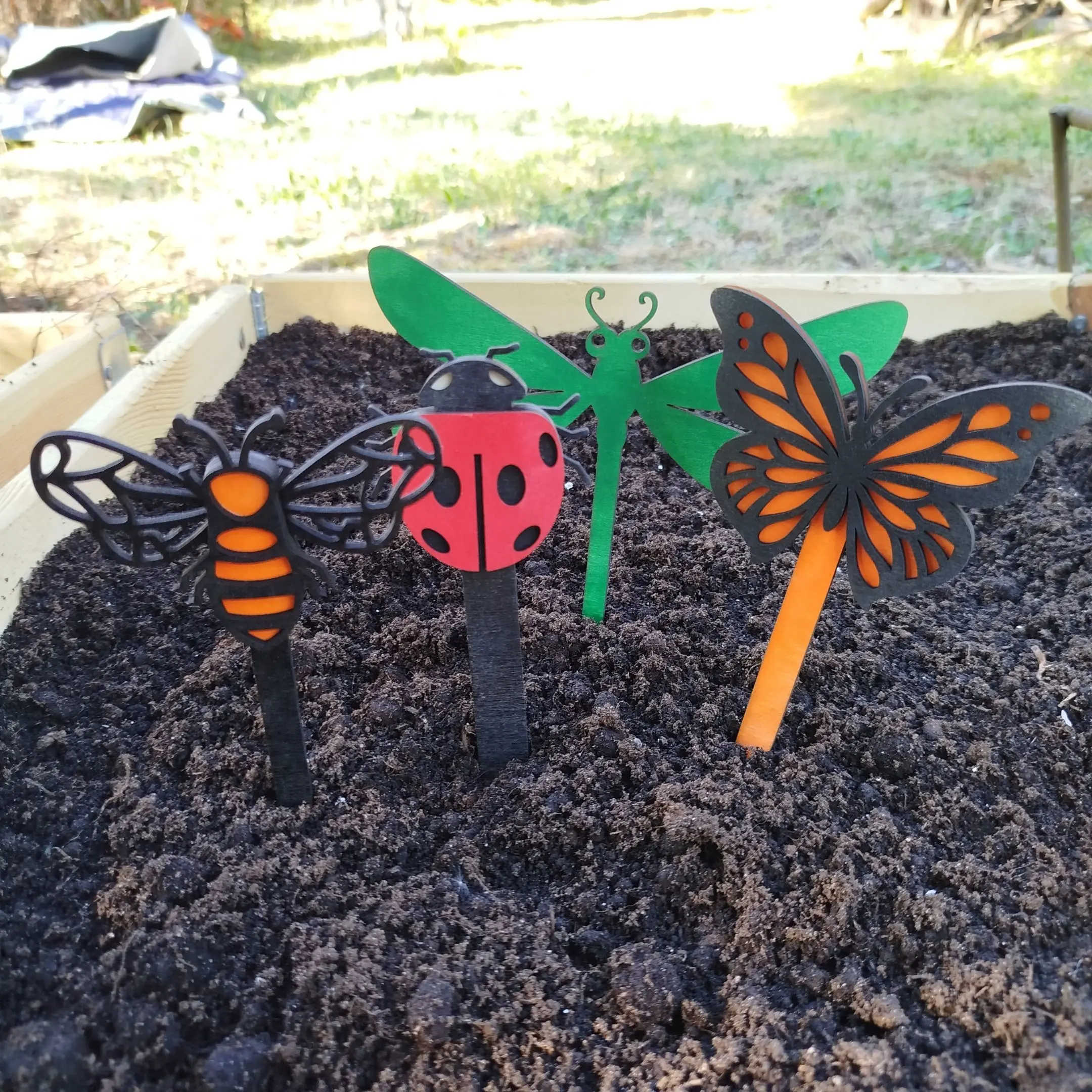 Thumbnail showing several colorful, layered wooden insects as part of a laser cut insects garden decor set