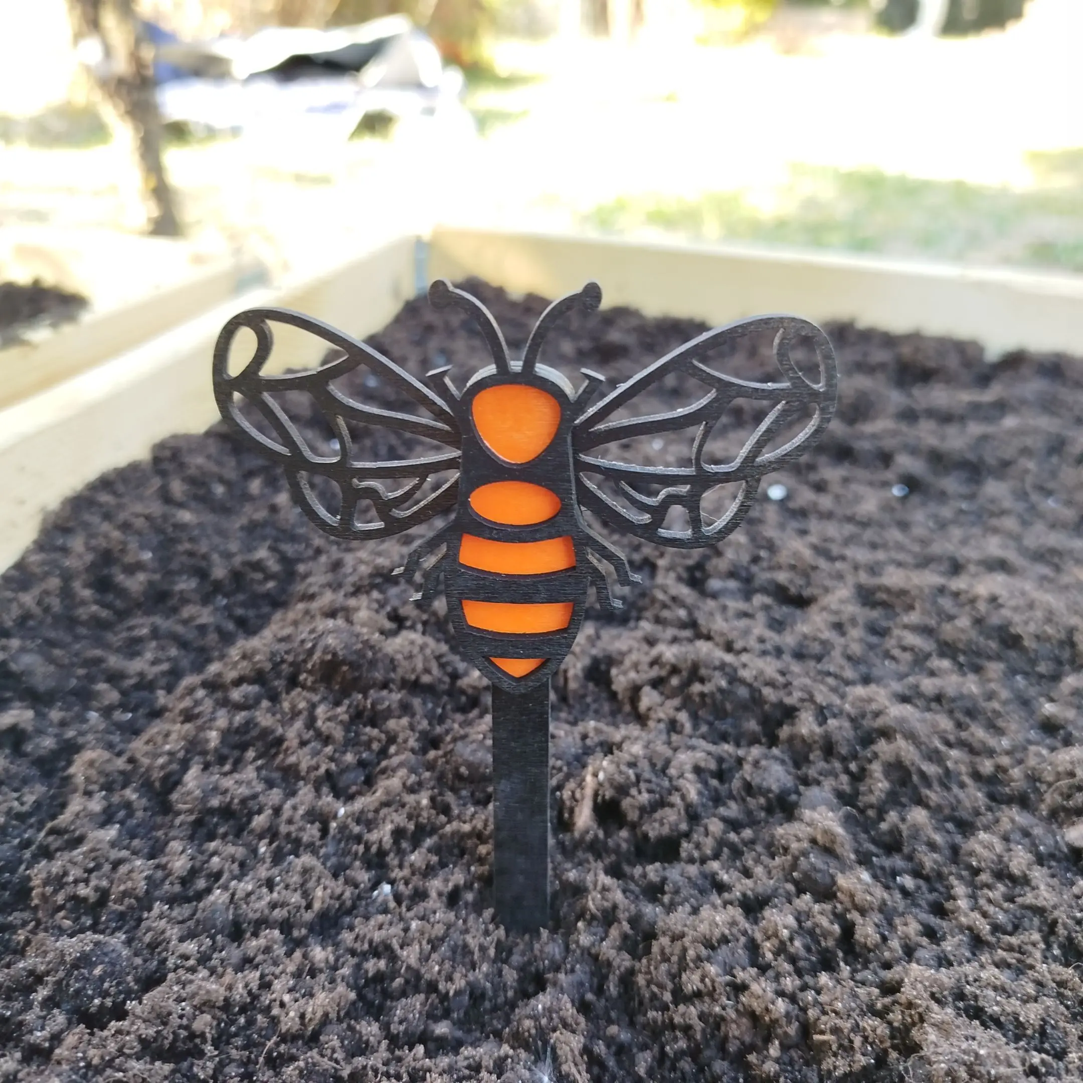Colorful layered wooden bee from a laser cut insects garden decor set