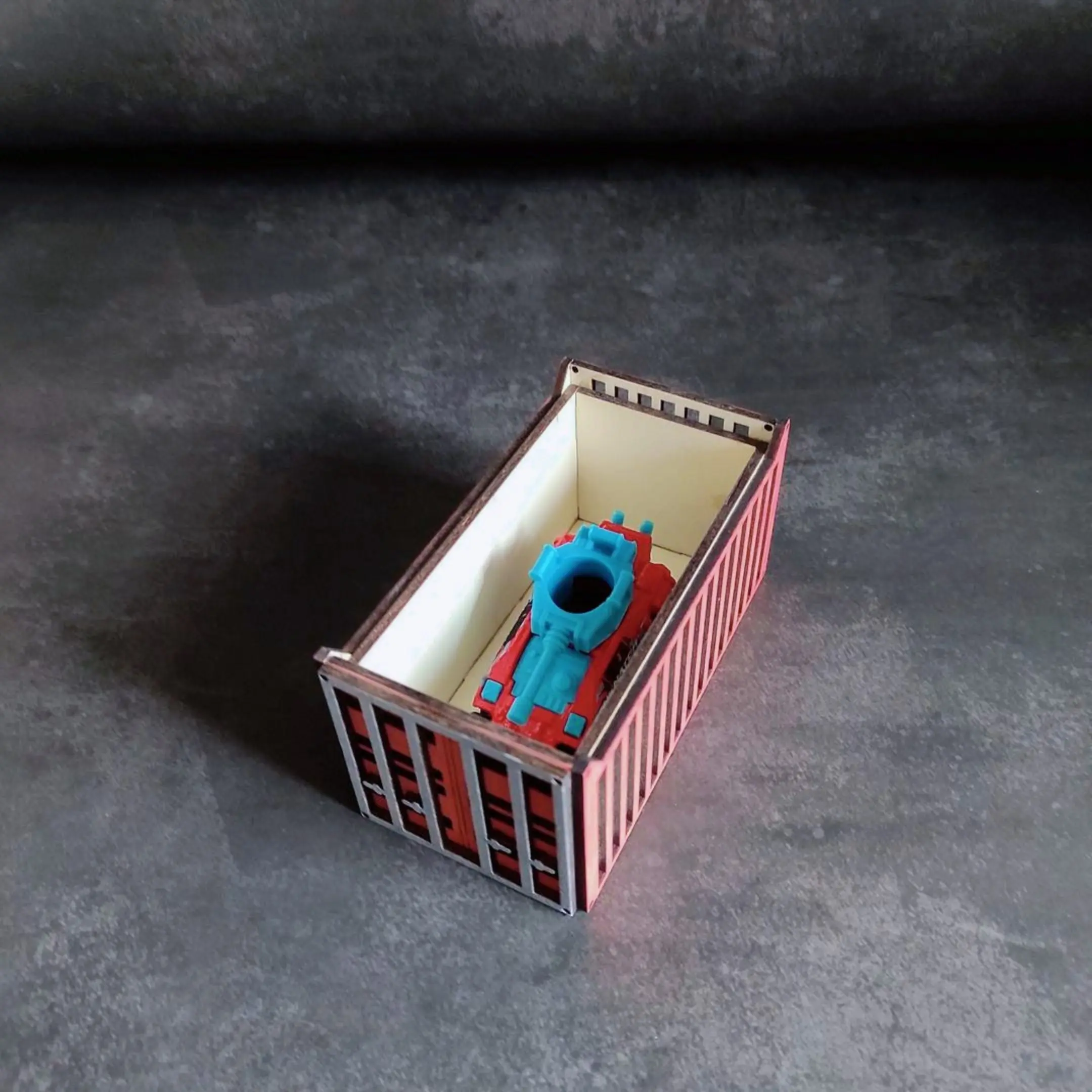 Laser cut Hot Wheels container holding a tank-shaped toy car