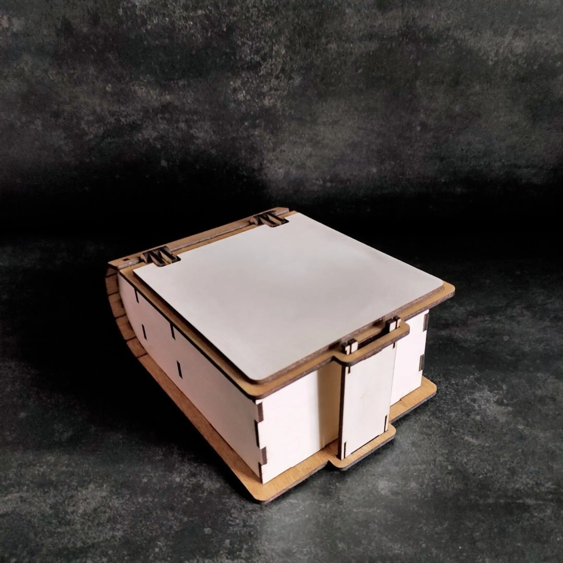 Laser cut book-shaped deck box for 100 sleeved cards, closed view.