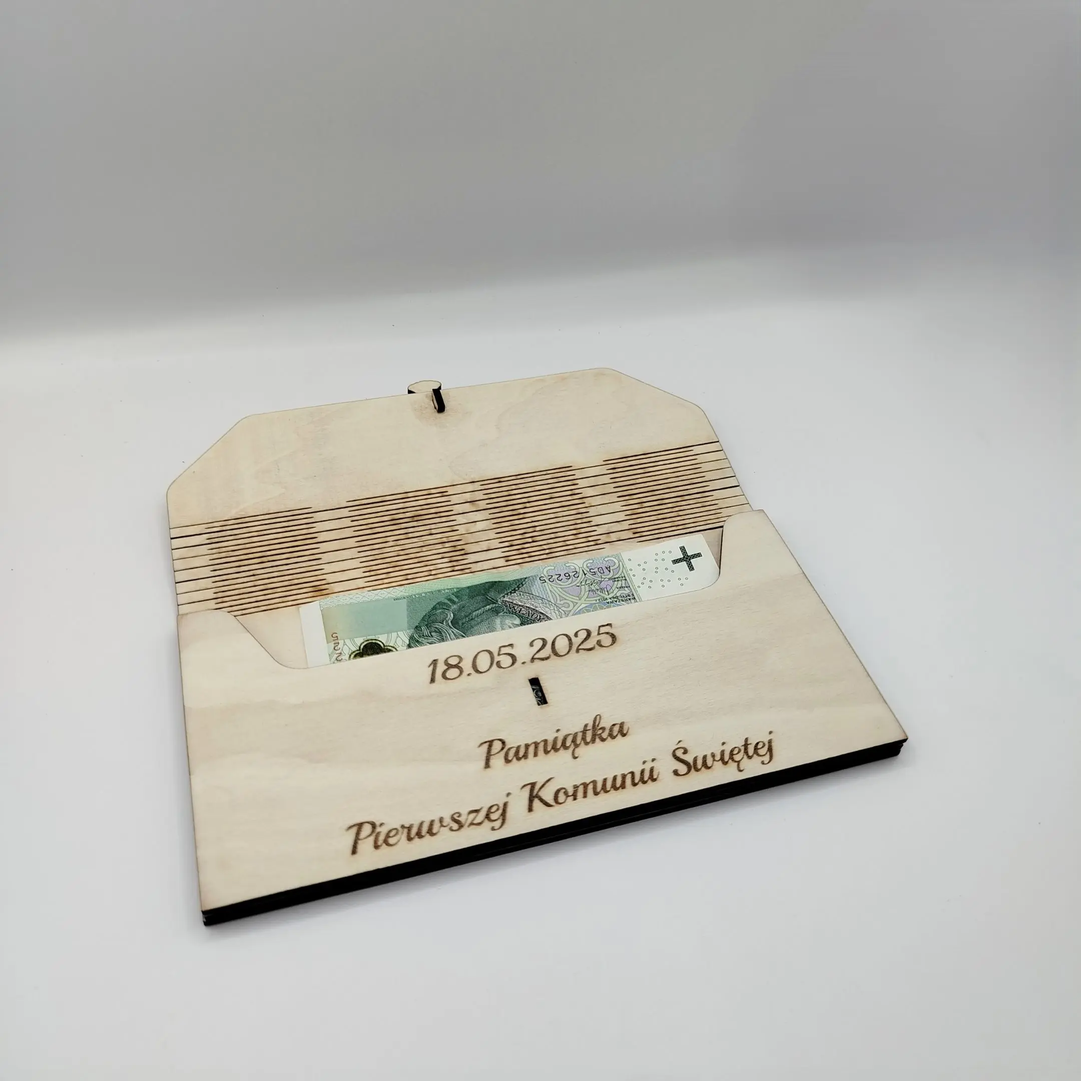Open laser cut Holy Communion envelope with a visible banknote placed inside.