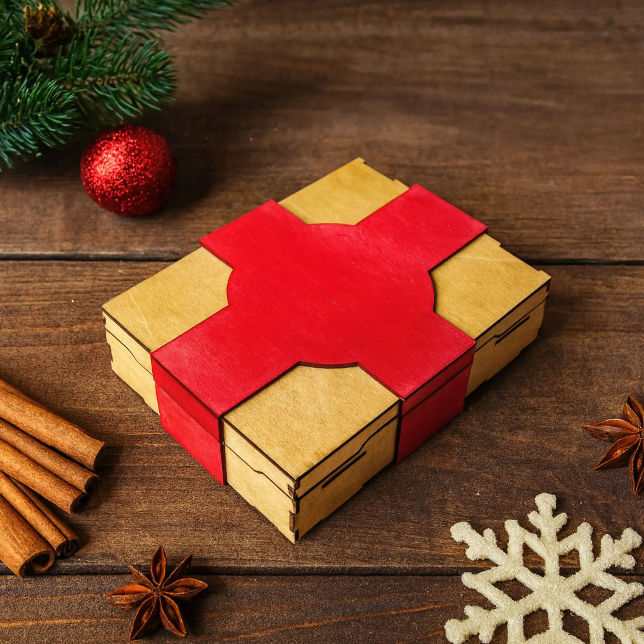 Laser cut Christmas game gift box on a wooden table with festive decorations, designed for Xbox, PlayStation, and Switch games.