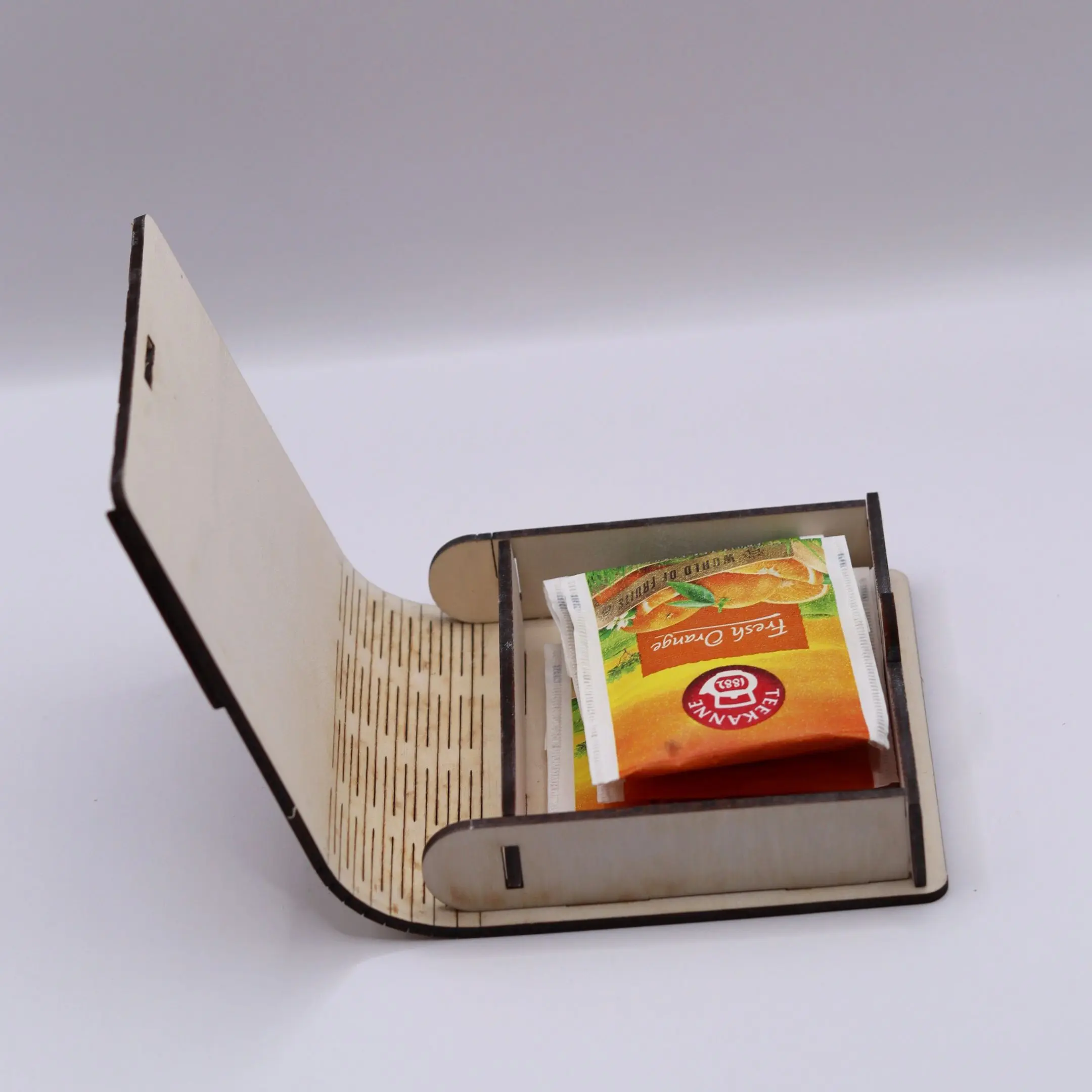 Open laser cut tea box gift with assorted tea bags inside