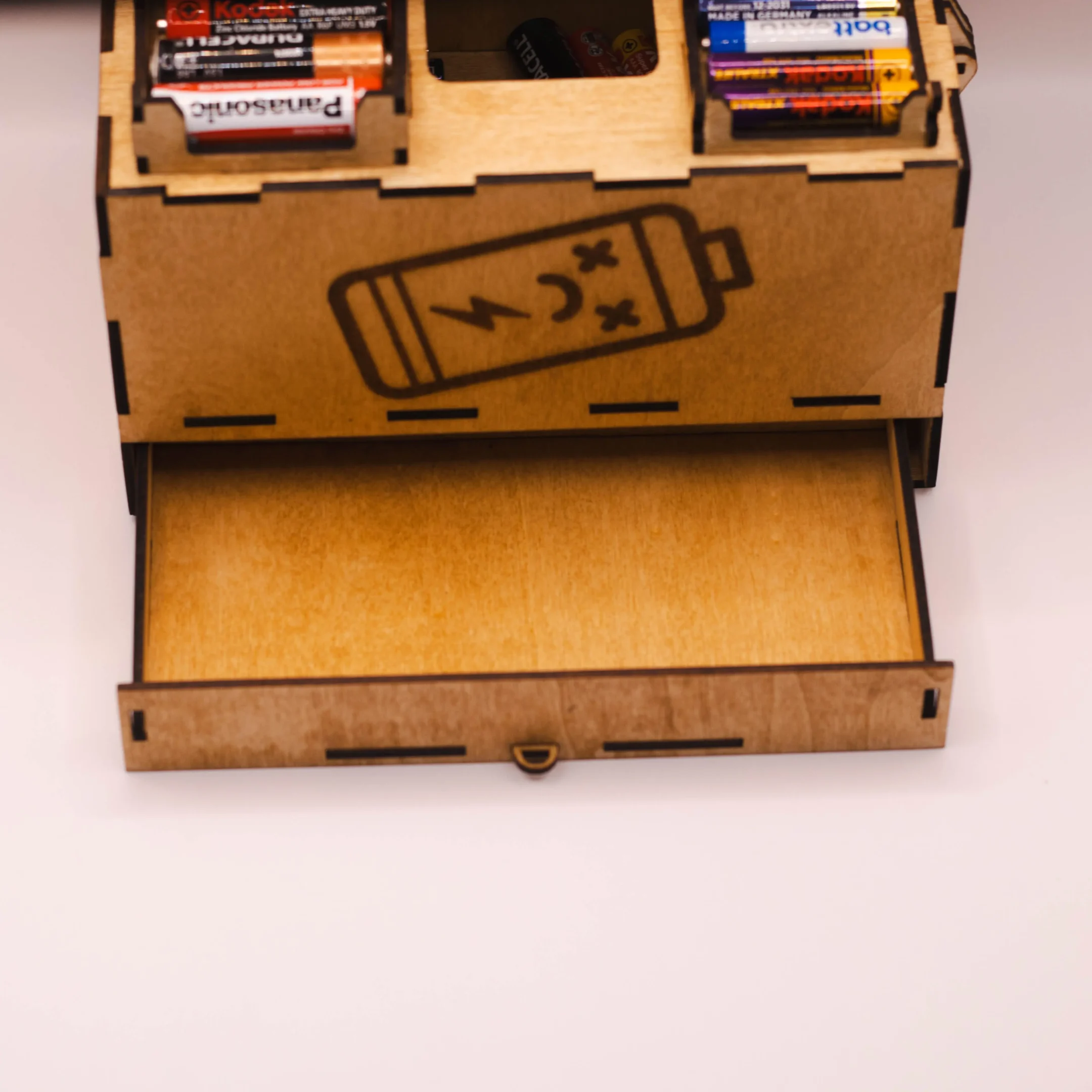 Close-up of the drawer for flat batteries in a laser cut wooden battery organizer