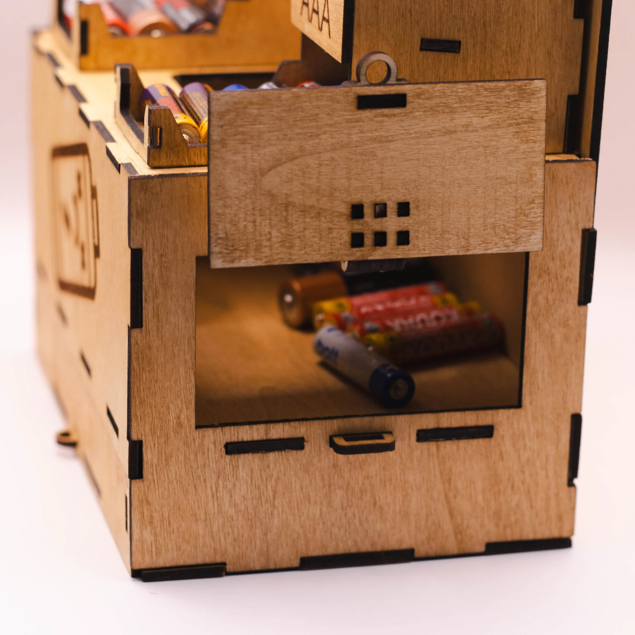 Close-up of the used battery compartment in a laser cut wooden battery organizer