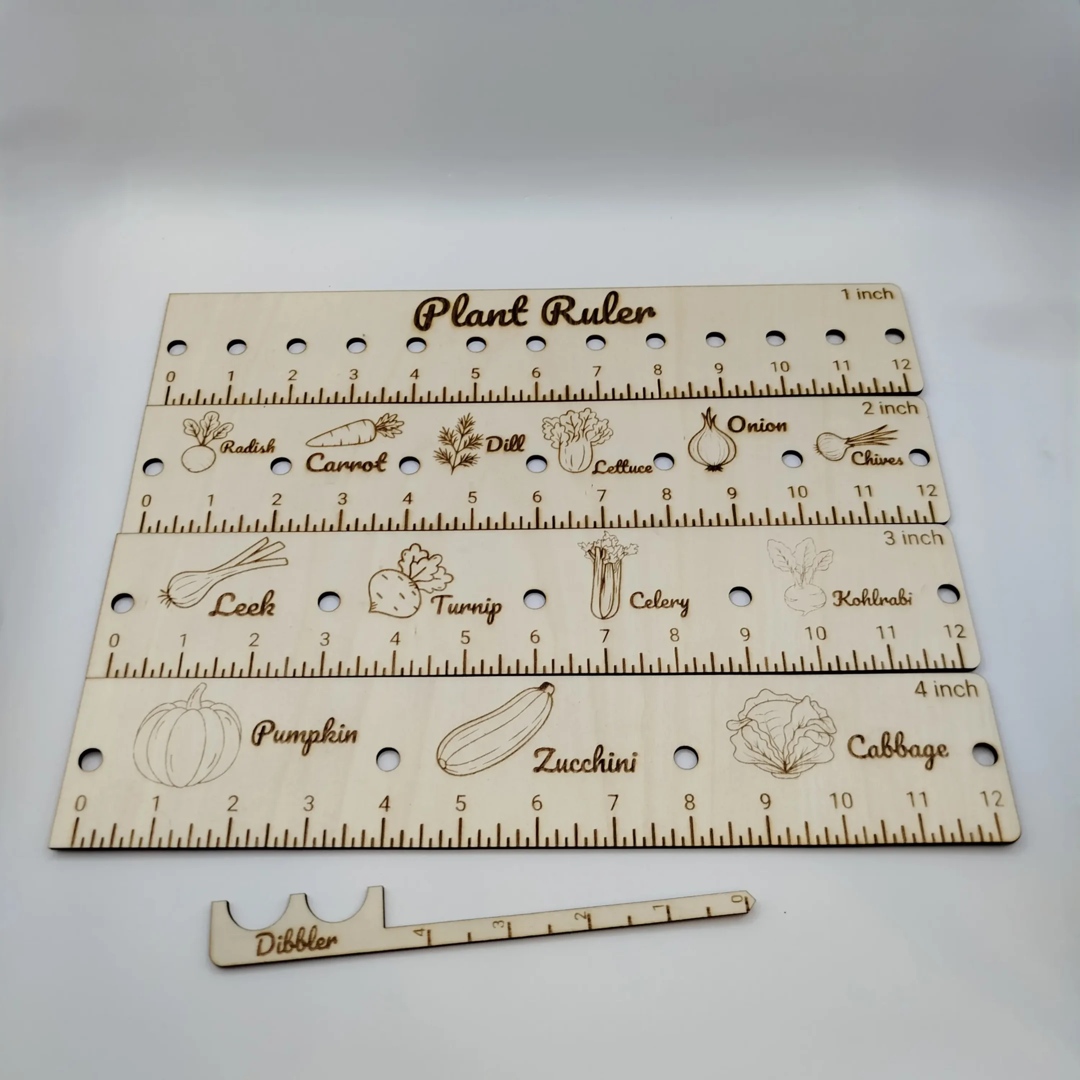 Full set of laser cut garden planting tools including rulers and dibbler displayed on a white background