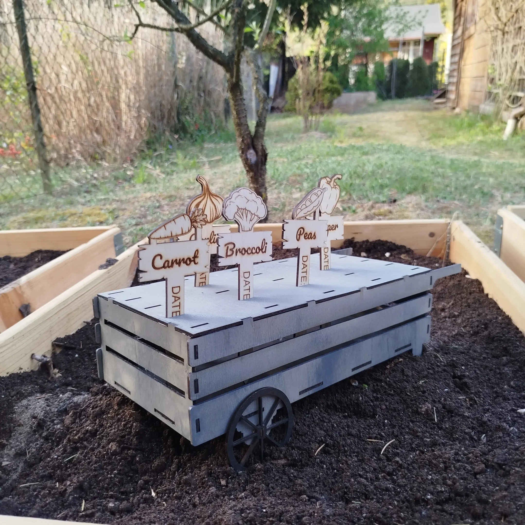 Laser cut wooden cart for organizing garden plant markers, with multiple compartments for easy storage and transport