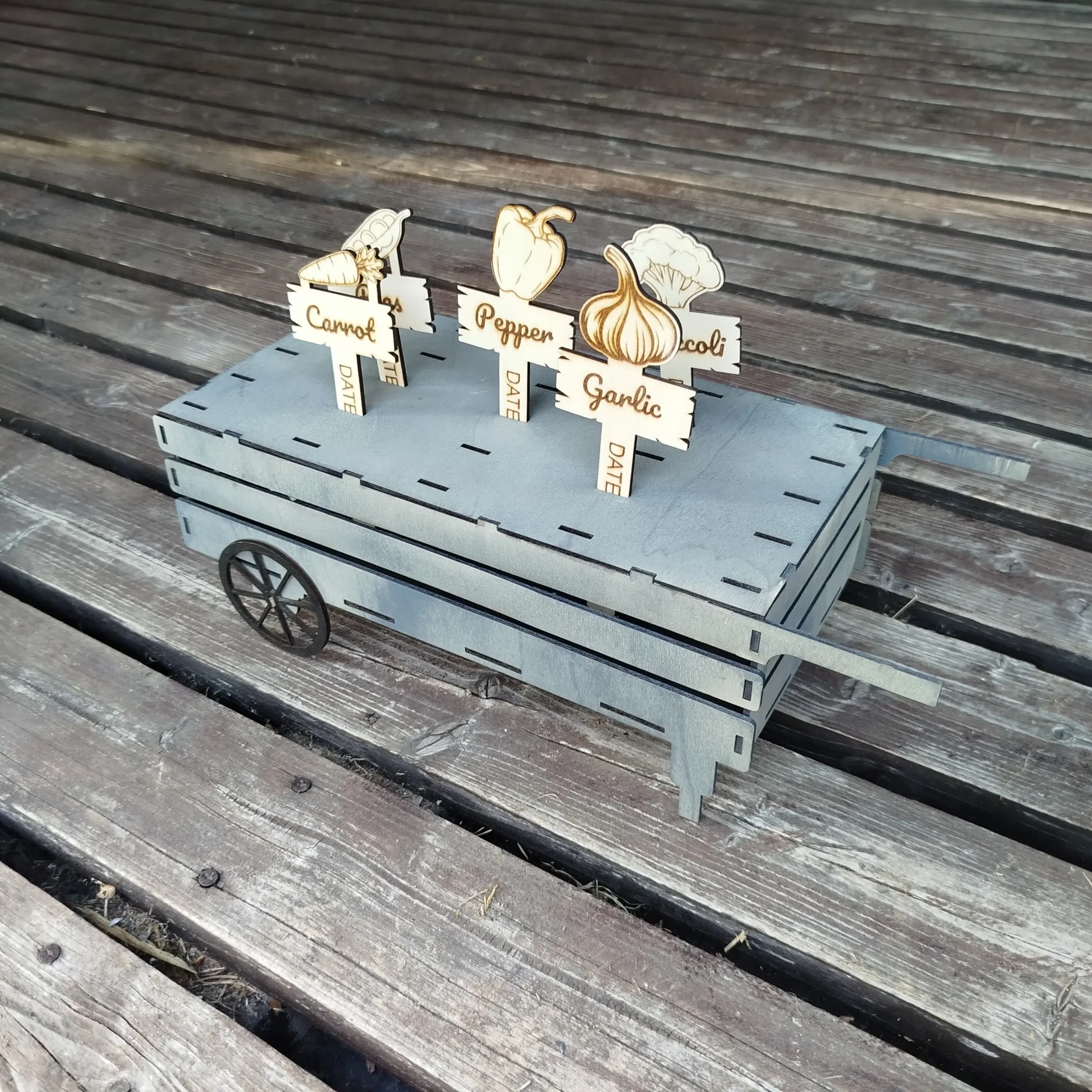 Laser cut wooden plant markers for vegetables and herbs, displayed without a holder or cart