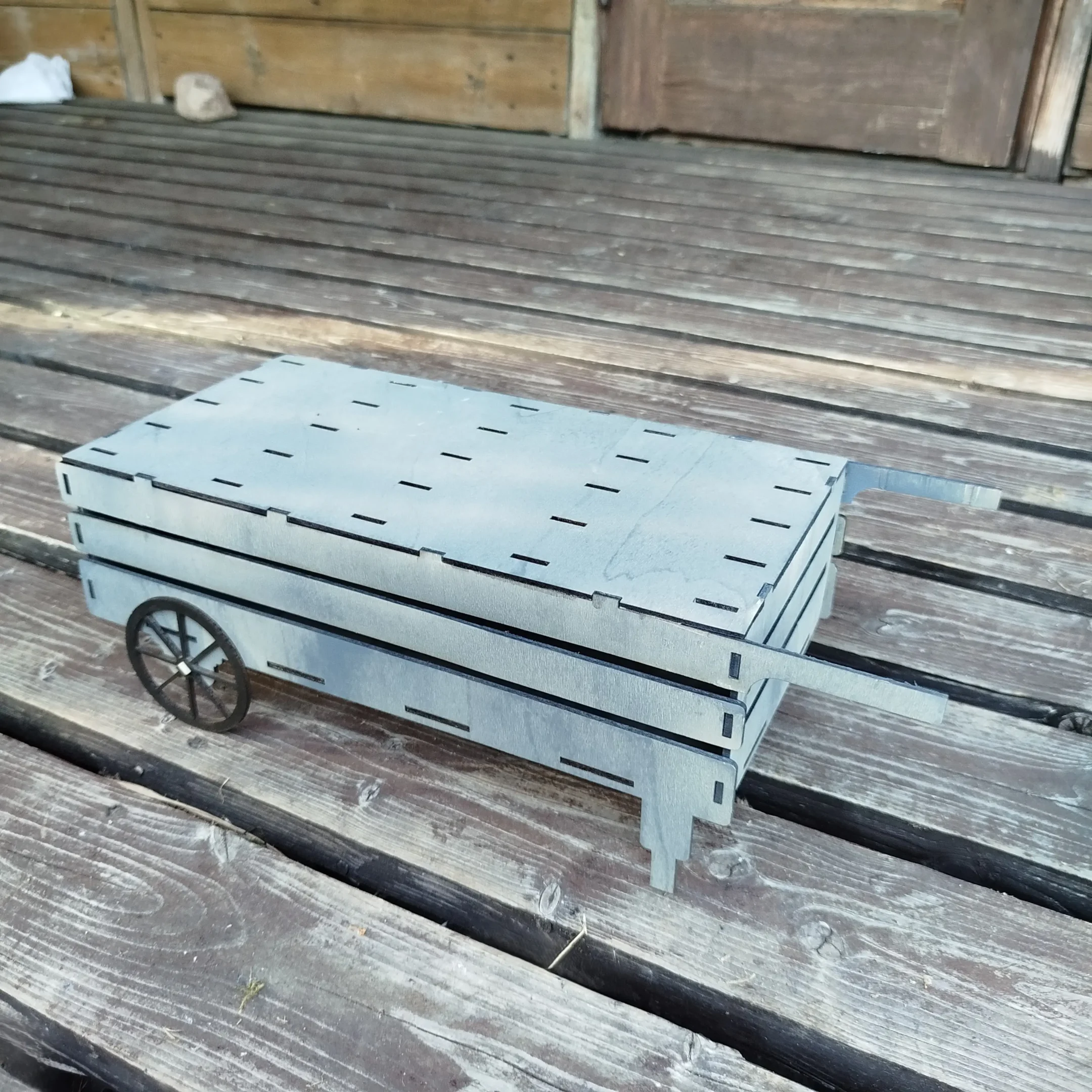 Empty laser cut wooden cart designed to store and organize garden plant markers