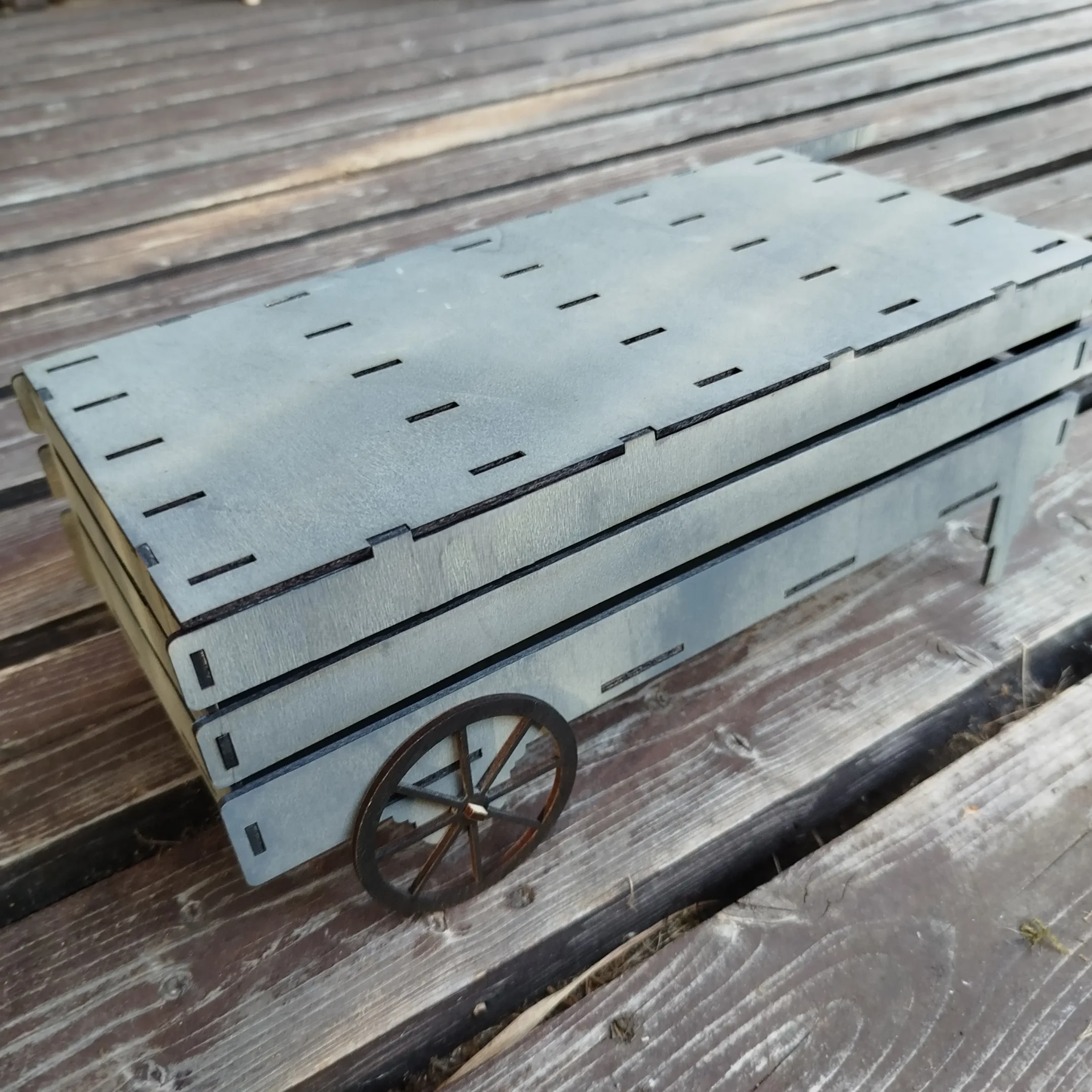 Empty laser cut wooden cart designed to store and organize garden plant markers