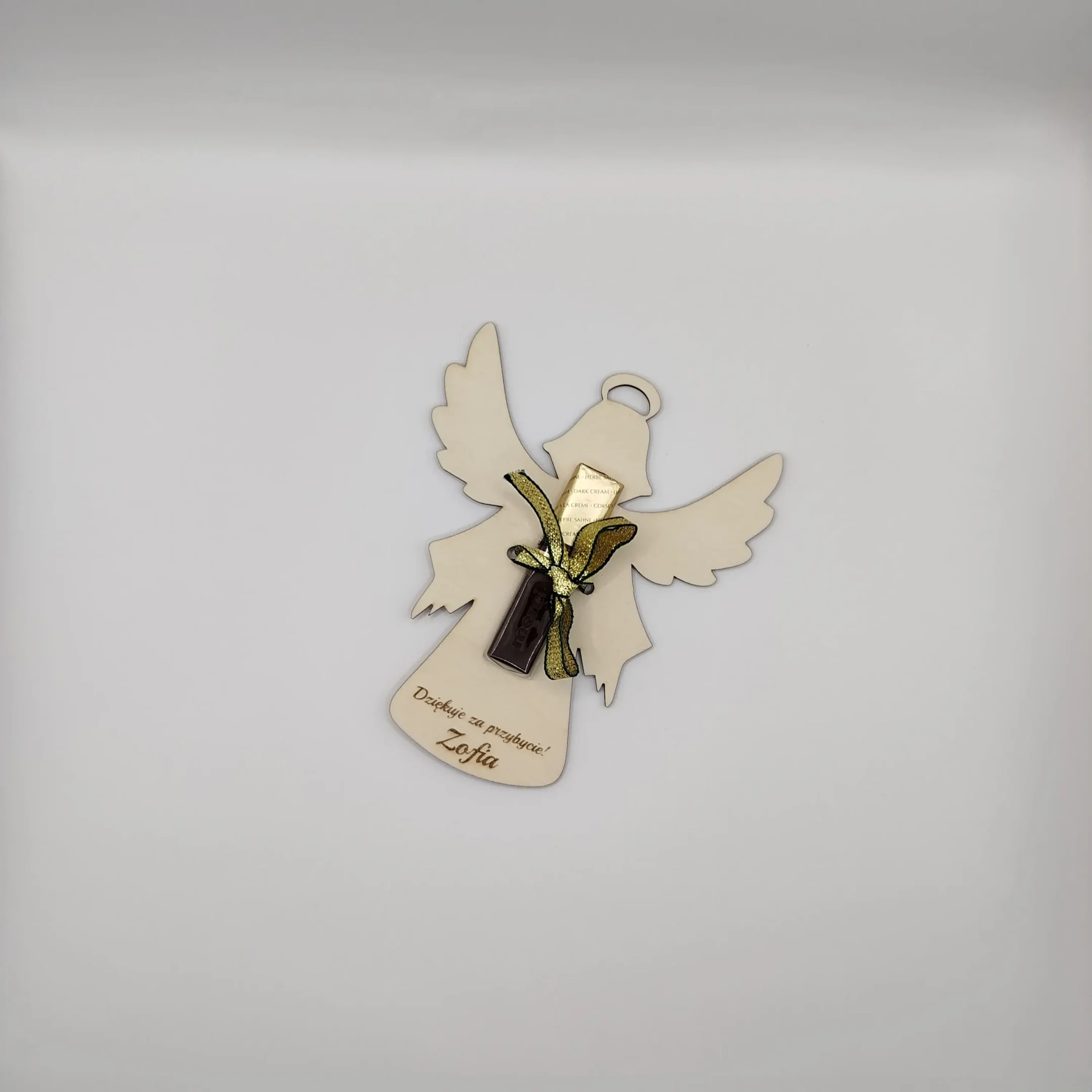 Cut-out laser cut angel favor box with Merci chocolate inside