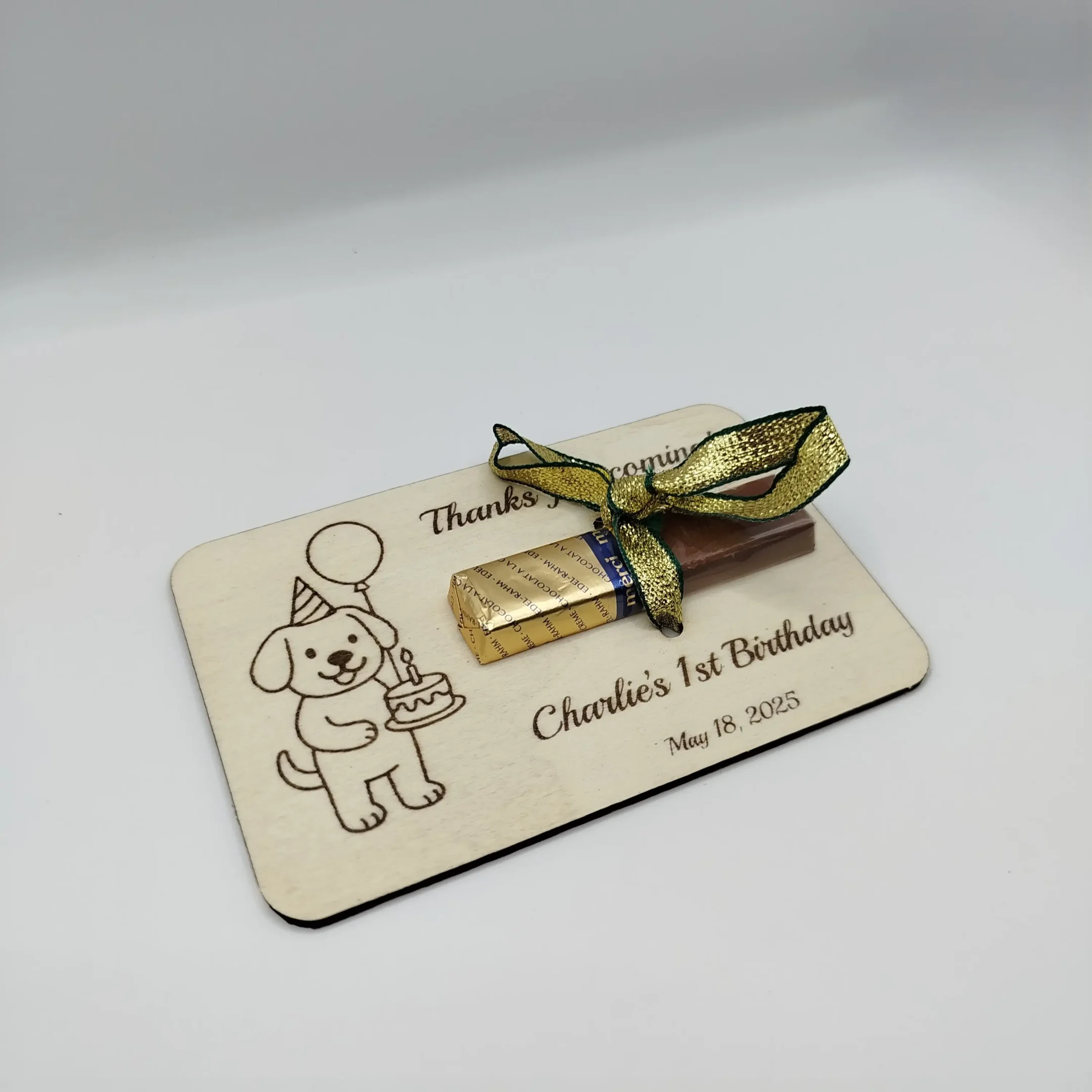 Laser cut wooden dog-shaped party favor with inserted Merci chocolate, perfect for guest appreciation