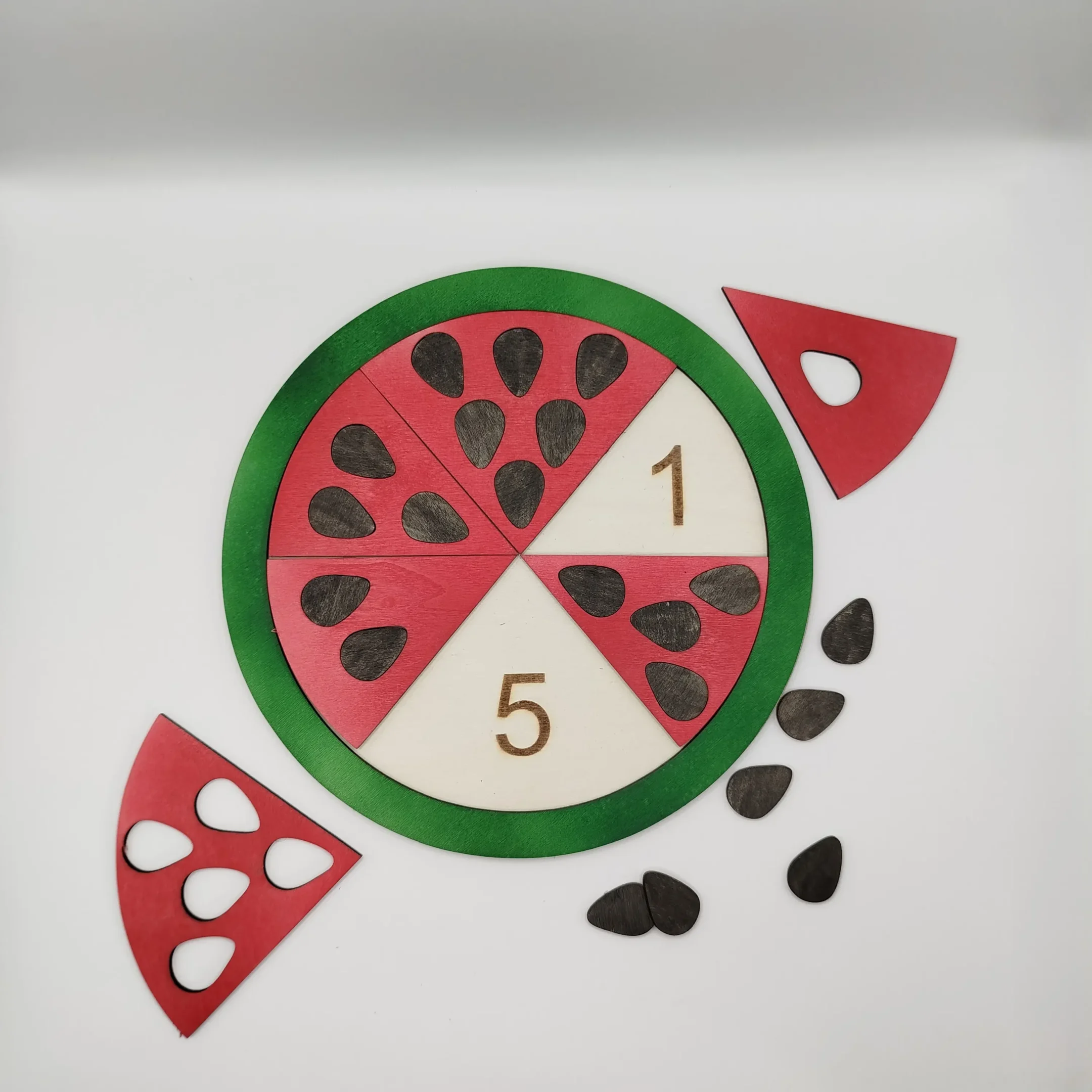 Wooden watermelon puzzle with two slices correctly placed, showing number alignment and position.