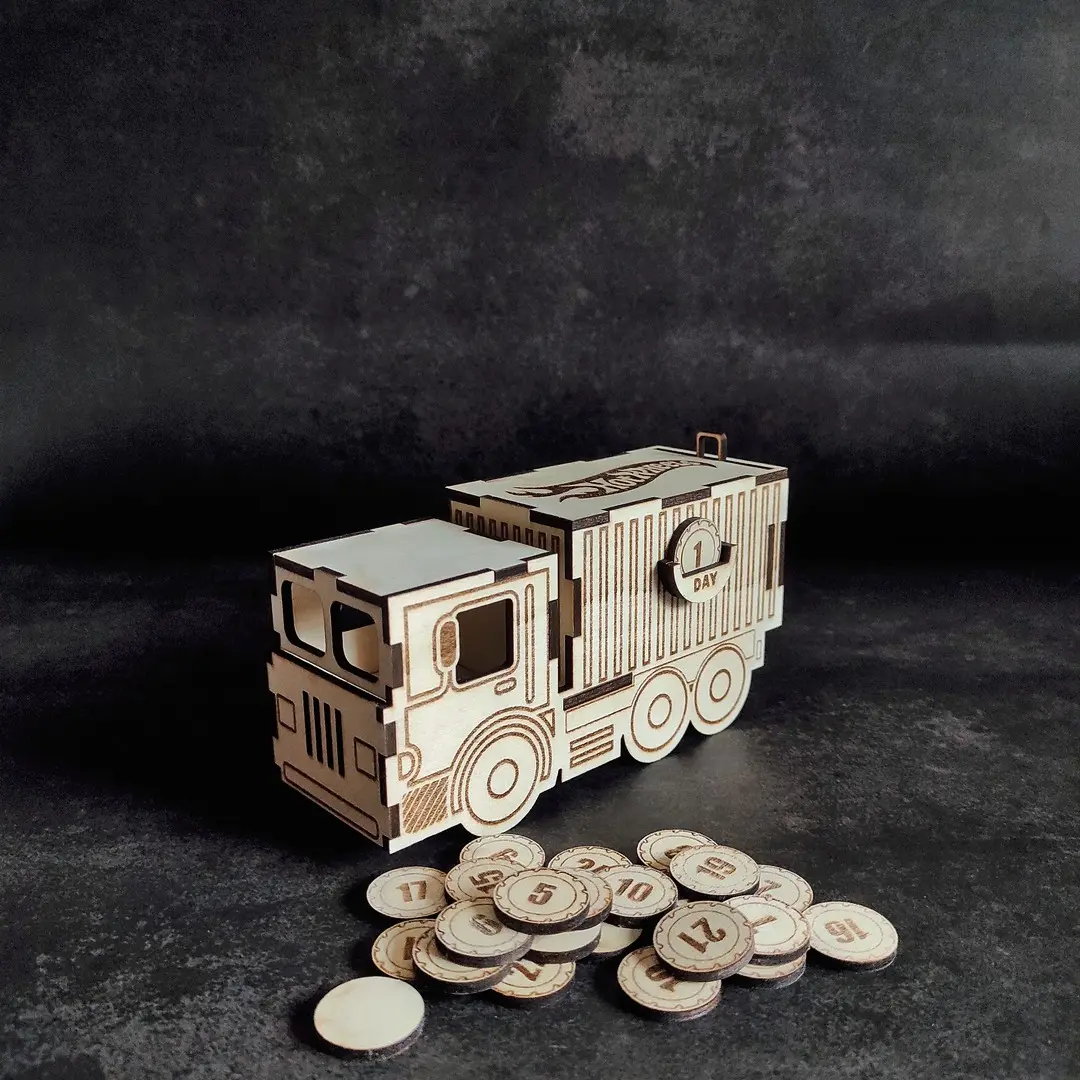 Laser cut Hot Wheels truck advent calendar with numbered compartments for mini cars.