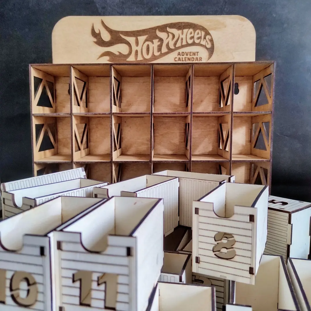 Laser cut Hot Wheels advent calendar with all 24 car slots removed and displayed in front.