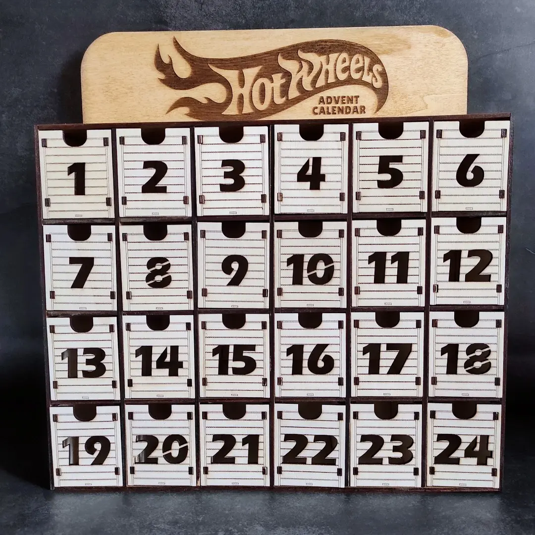 Miniature view of a laser cut Hot Wheels advent calendar with 24 garage-style car slots.