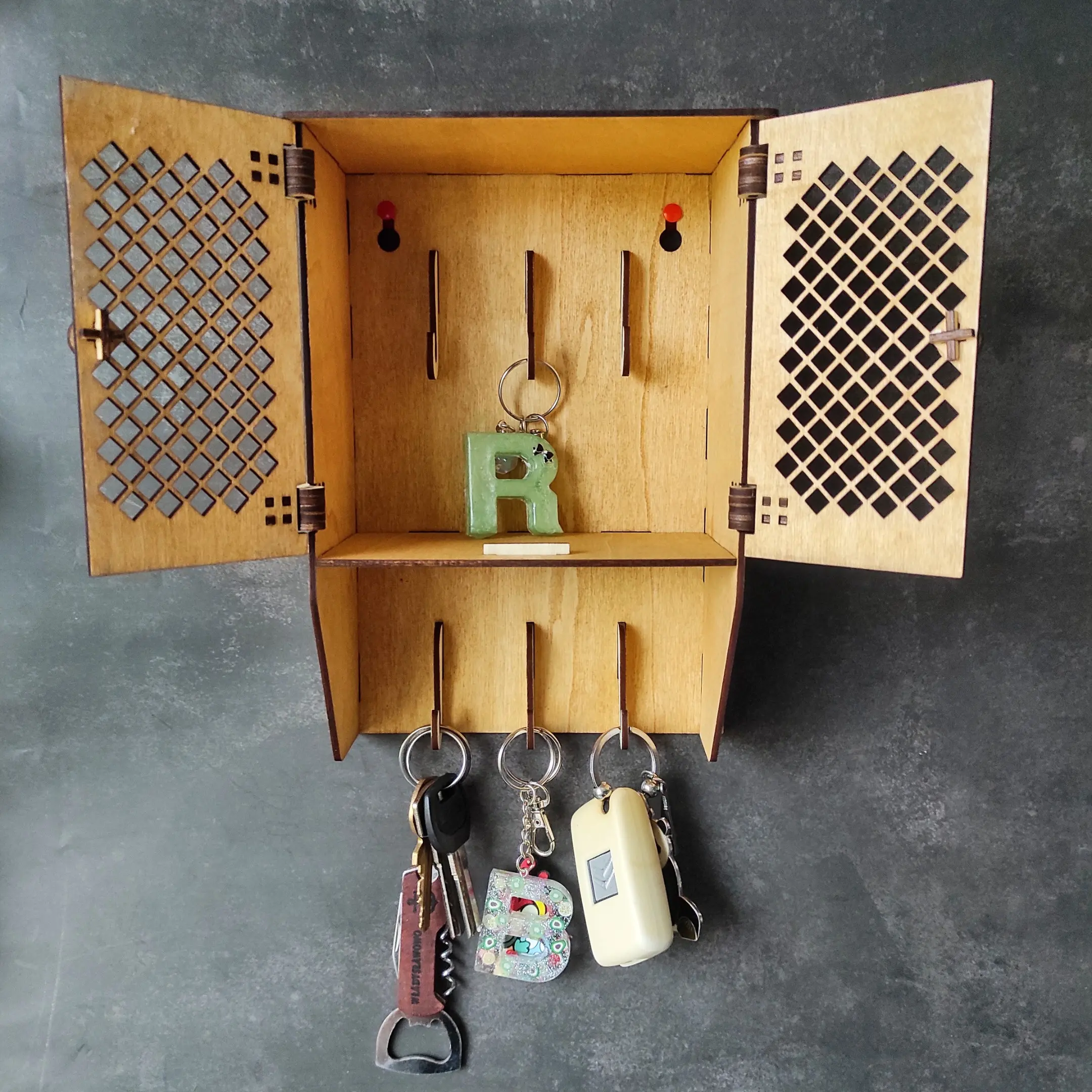 Open Laser Cut Rustic Key Cabinet with example keys hanging inside.