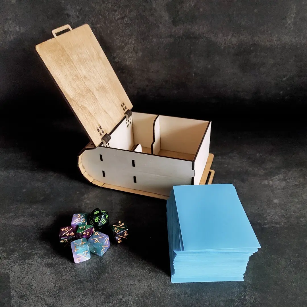 Empty deck box with cards and dice placed beside it.